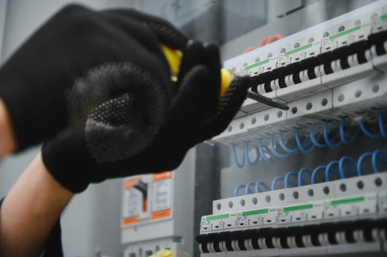 Les électriciens travaillent pour connecter des fils électriques dans le système, le tableau de distribution, le système électrique dans l'armoire de commande